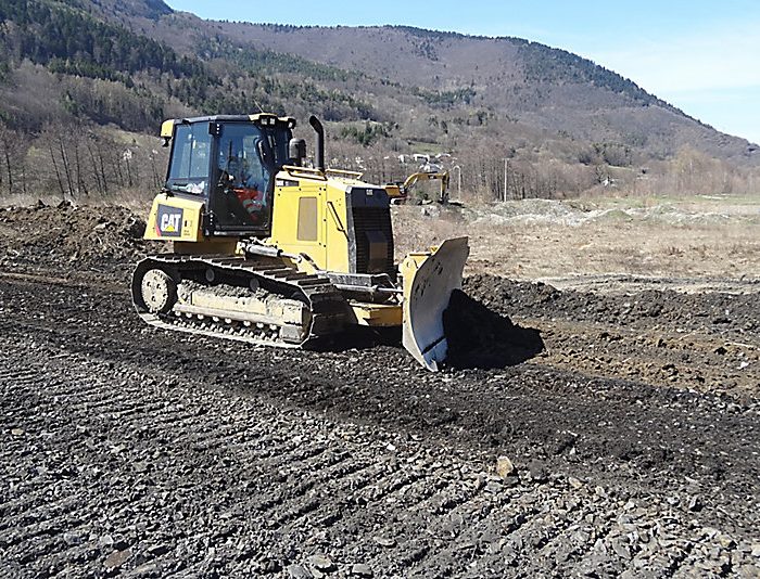 Track type tractor CAT D6K clearing up construction area