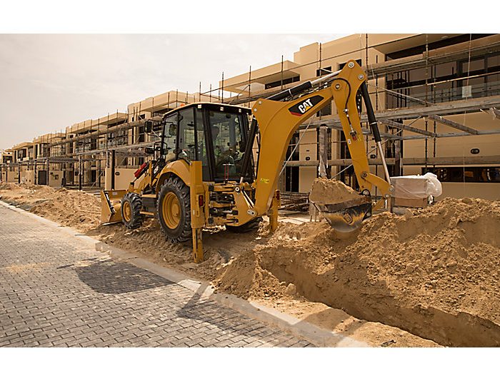 Backhoe loader CAT 428F2 moving earth in construction area